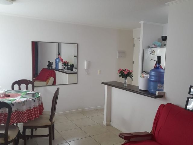 Living comedor con mesón hacia la cocina americana, departamento en Condominio Nuevo Barrio, Iquique
