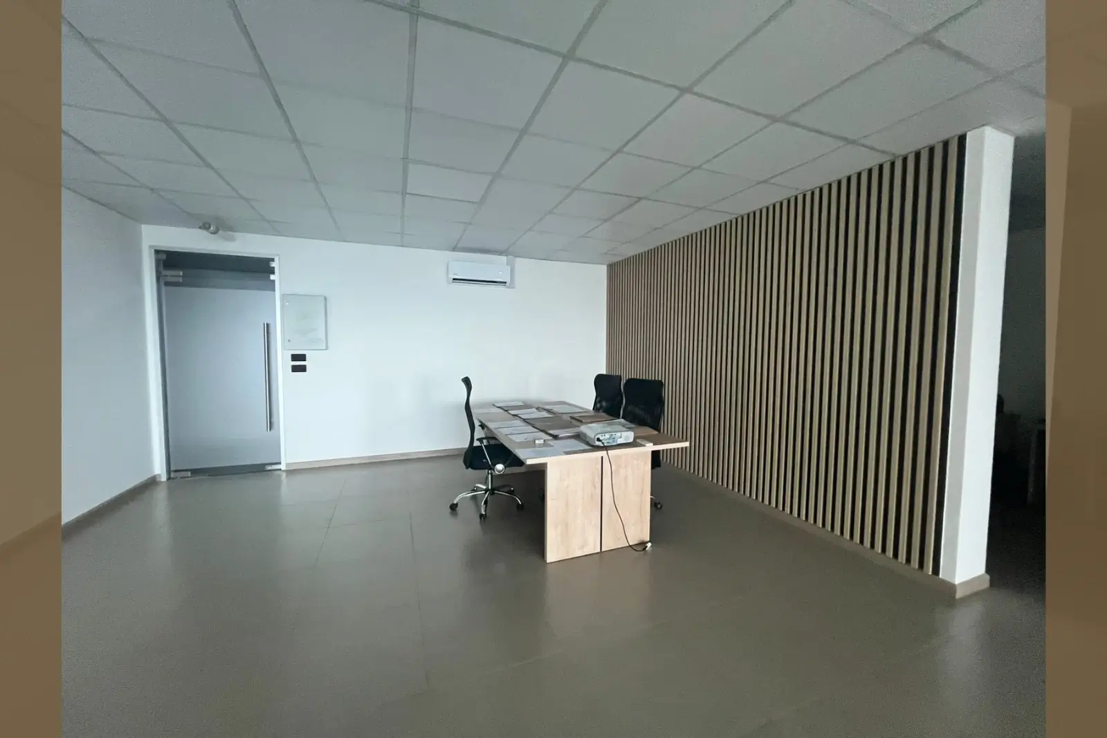 Sala de reuniones con mesa, sillas y proyector, oficina en Torre Capital, Iquique